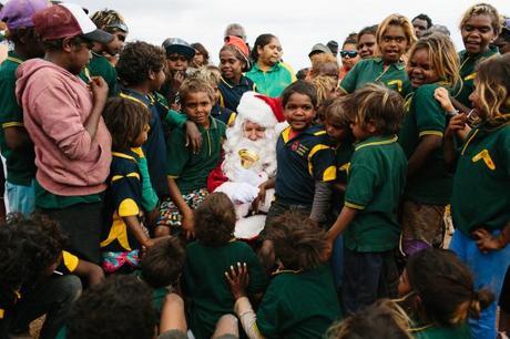Santa seated in the desert surrounded by eager kids. Image Cameron Zegers Photography. 