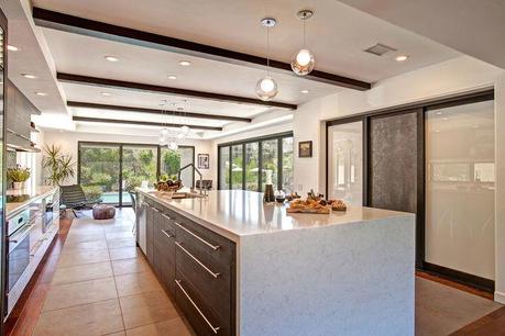 This Encinitas kitchen remodel features white countertops and cabinetry.
