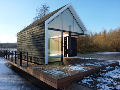 Prefab cabin with glass walls and folding wood door