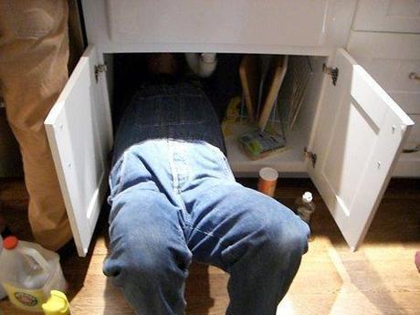 Plumber under cabinet