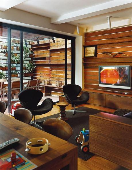 The Zizmors extended their living room by installing an 8-by-15-foot sliding glass door, which leads to an outdoor dining area built six feet above the alley. To make the outdoors feel like it's part of the living room, and not a separate patio, they ran 