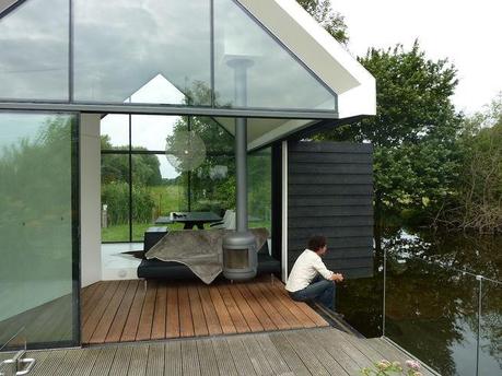 Prefab cabin with fold out wall that opens onto lake