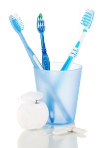 Toothbrushes, chewing gum and dental floss isolated on white