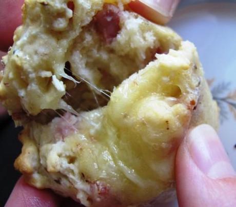 Ham and cheese muffin being pulled apart