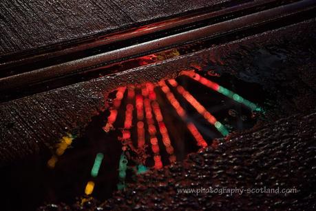 Photo - the big wheel reflected in a puddle beside the tramline in Edinburgh's city centre