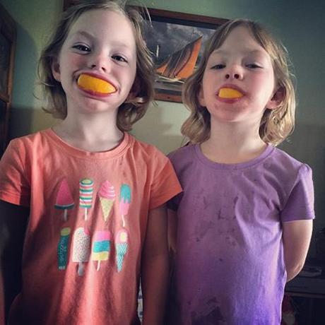 The kids cooling down with some fruit and being silly. They are having a great time on their holiday. 