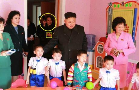 Kim Yo Jong (circled) with a gold ring on the third finger of her left hand (box) at the Pyongyang Baby Home and Orphanage on January 1, 2015 (Photo: Rodong Sinmun).