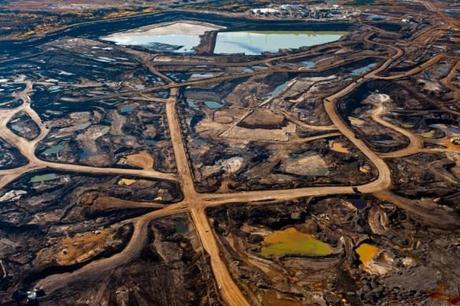 (Tar Sands’ hellish landscape of ruined Earth and toxic tailing ponds. Image source Occupy.)