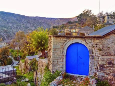 Many of the homes have blue doors in the mountainside village of Kalarrytes in Greece.