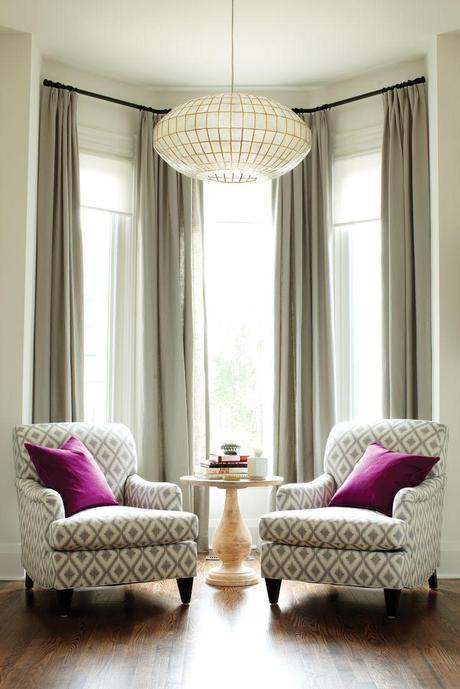 How to make the room look bigger: Living room, two armchairs, large chandelier, tall windows, drapes hung REALLY high!