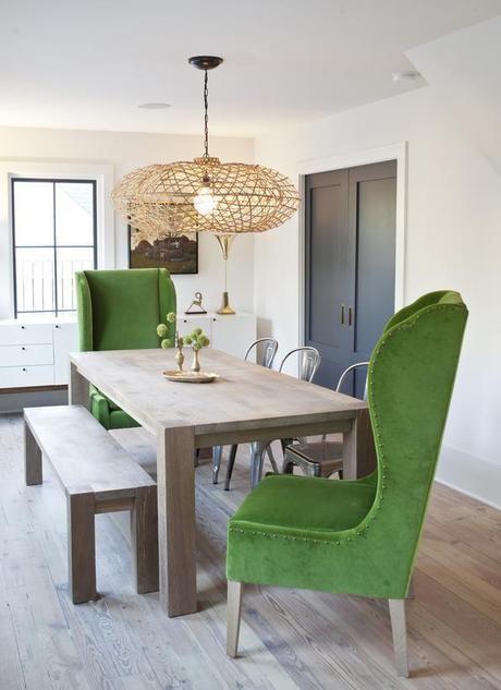 Rustic dining room with emerald green chairs