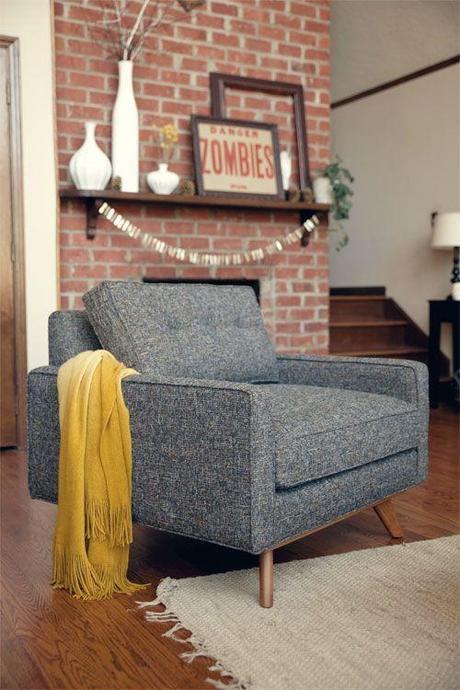chair love. This is pretty much my style to a T. I love the brick wall, the chair, the floor, the throw, the rug, the vases, and especially that framed zombies sign and empty frame. Just a small frame of the space and it feels nice and open. love.