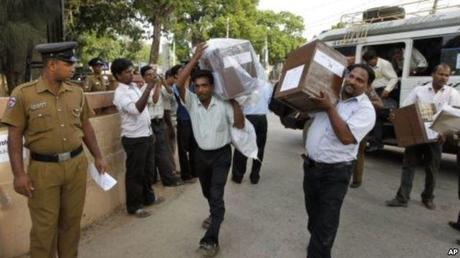 Sri Lankan election officials carry ballot boxes under police guard. (Photo: VOA News)