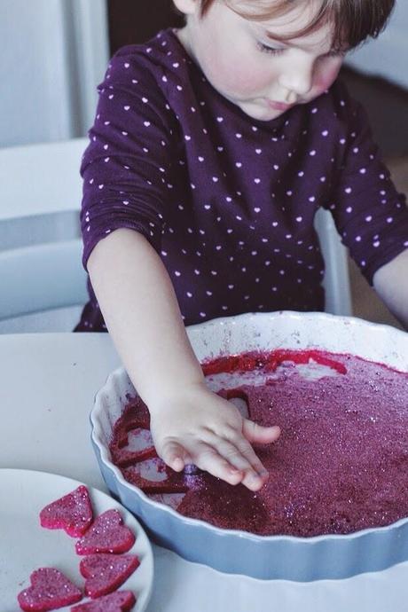 homemade raspberry yogurt gummy glitter hearts.