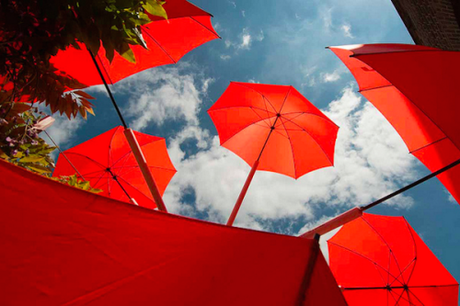 red umbrellas against the sky