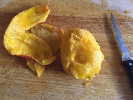 Chopping up fresh and very ripe mangoes
