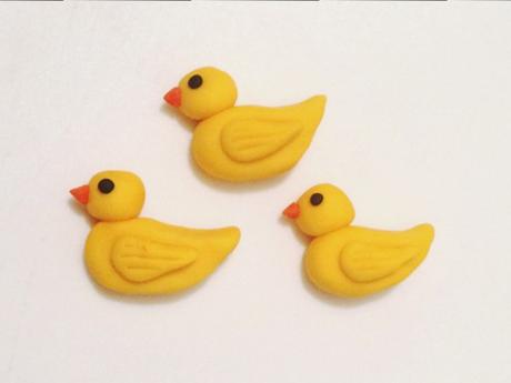 three yellow ducks made from fondant for baby shower cupcakes handmade