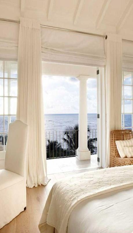 white bedroom with beautiful ocean view