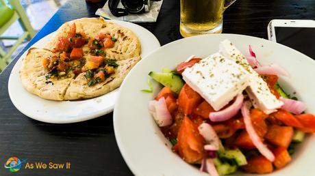 Greek salad, served with Greek bread and a glass of Mythos, the Greek beer