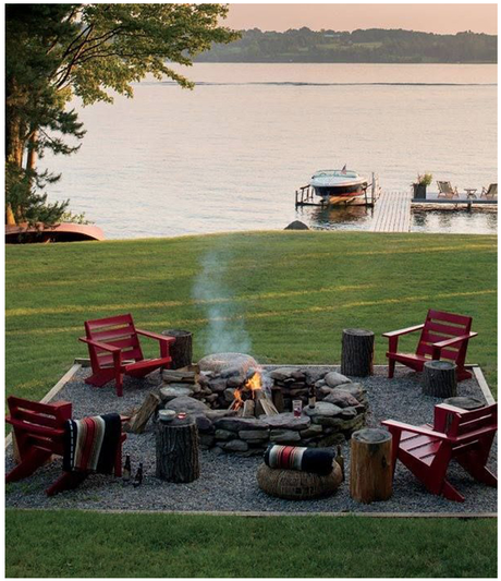 fireplace with red adirondack chairs backyard with beach