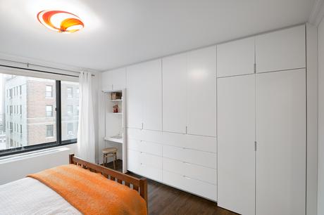 Upper East Side master bedroom with custom storage unit and desk