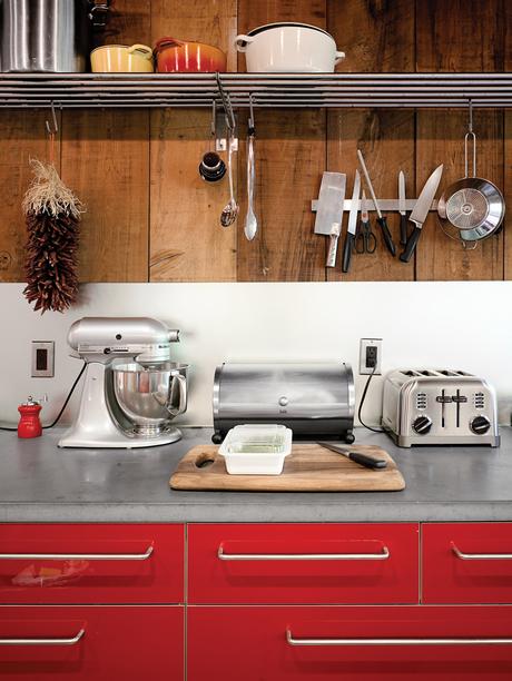Harry Bates designed this simple cedar house for a young family in New York in 1967. Forty years later he updated the place for its new owners, Joe Dolce and Jonathan Burnham. The addition of bright red cabinetry in the kitchen introduces a contemporary s