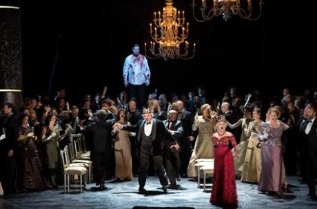 Banquo's ghost (Rene Pape) haunts Macbeth (Zeljko Lucic) as Lady Macbeth (Anna Netrebko) distracts the onlookers