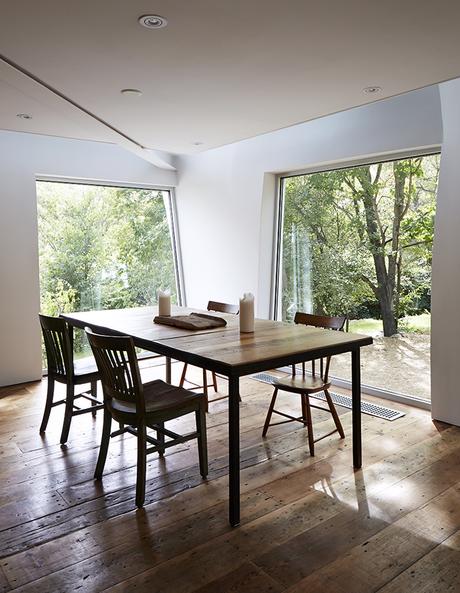 Dining table and chairs with large windows