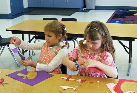 Children learning how to cut out shapes and to use in craft projects.