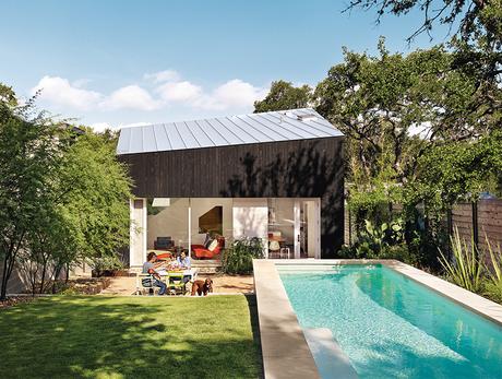 Modern Texan addition and renovation with outdoor pool and cypress paneling and metal roof