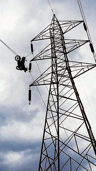 up above the electric line ~a motor-bile on the wire !!
