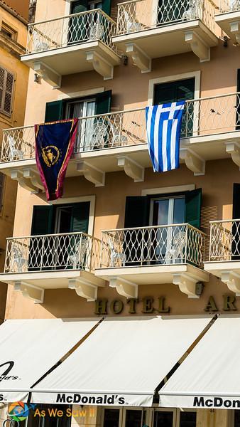 A balcony proudly displays the Greek flag on Ohi Day in Corfu