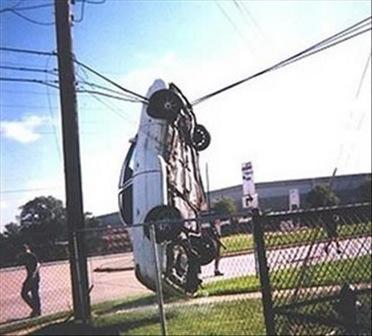 car dangling from wires