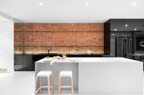 Modern kitchen with glossy black cabinets and a white island