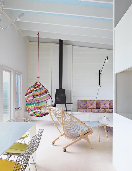 Fire Island living area with a PP130 Circle Chair by Hans Wegner and a wood-burning stove