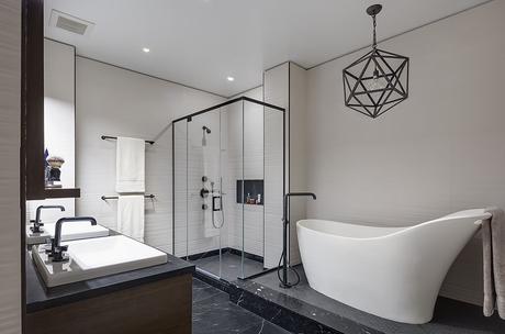 Master bathroom with a freestanding tub and marble floors