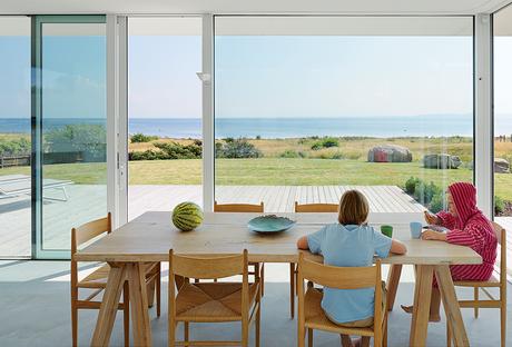 Modern Swedish family dream getaway with Ilva table and Carl Hansen & Søn chairs in dining area