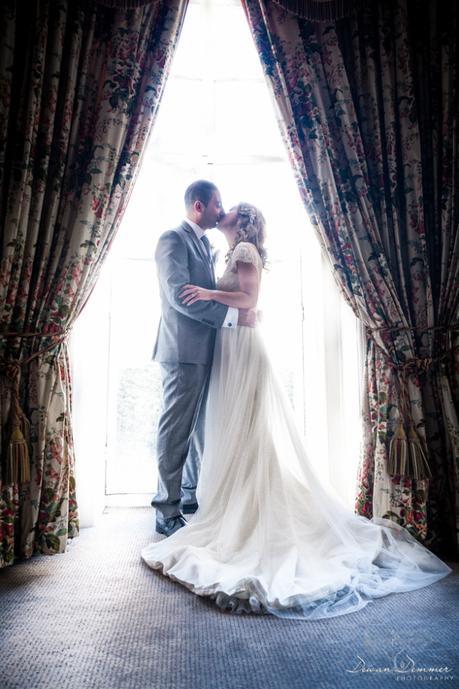 bride-and-groom-kiss-by-window