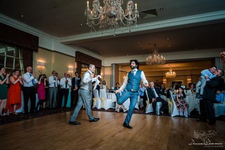 Groom and brother greek dancing at hendon hall hotel