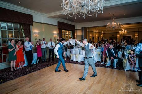 Groom and brother greek dancing at wedding