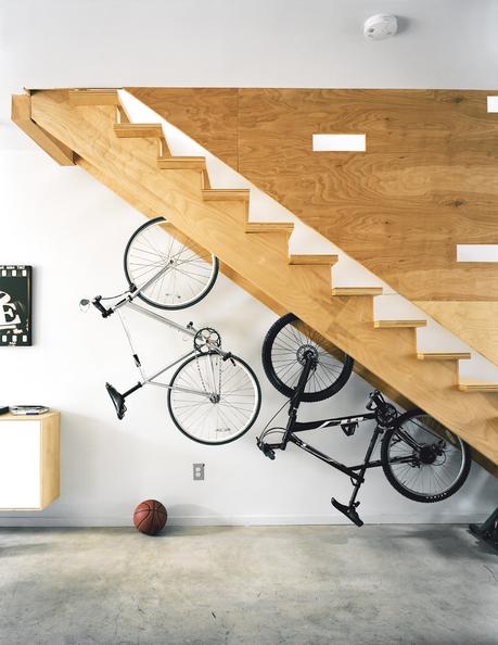 Plywood hanging bike rack by staircase