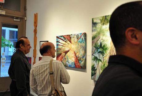 Art enthusiasts viewing paintings by Portland, Oregon artist Cedar Lee at Attic Gallery