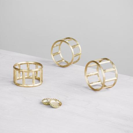 Sculptural wheel-shaped brass bottle opener