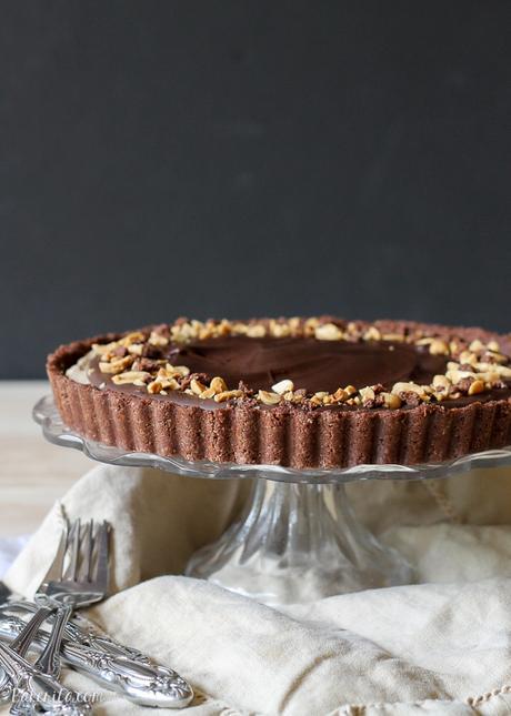 This No Bake Chocolate Peanut Butter Tart has a rich peanut butter filling topped with chocolate ganache for a decadent treat you won't believe is gluten free, refined sugar free, and vegan!