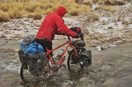 Kevin crossing a half frozen stream barefoot as its snowing. Miserable!