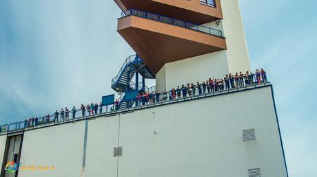 Shipside view of people watching our ship pass through a lock.