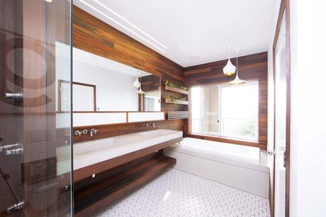 Modern wood-lined bathroom renovation with white tile