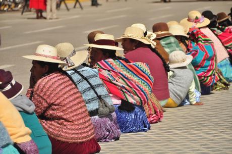 Typical Andean ladies: the hat, the cloth bag, the long braids, and the colorful pleated skirts. In everywhere except the largest cities, this is how the women always dress.