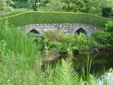 stone bridge by a pond in french garden