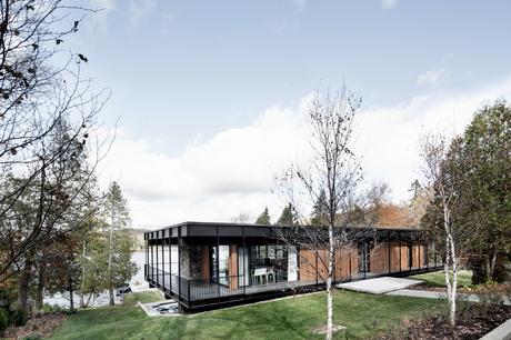 Midcentury Quebec home clad cedar, stone, and aluminum. 